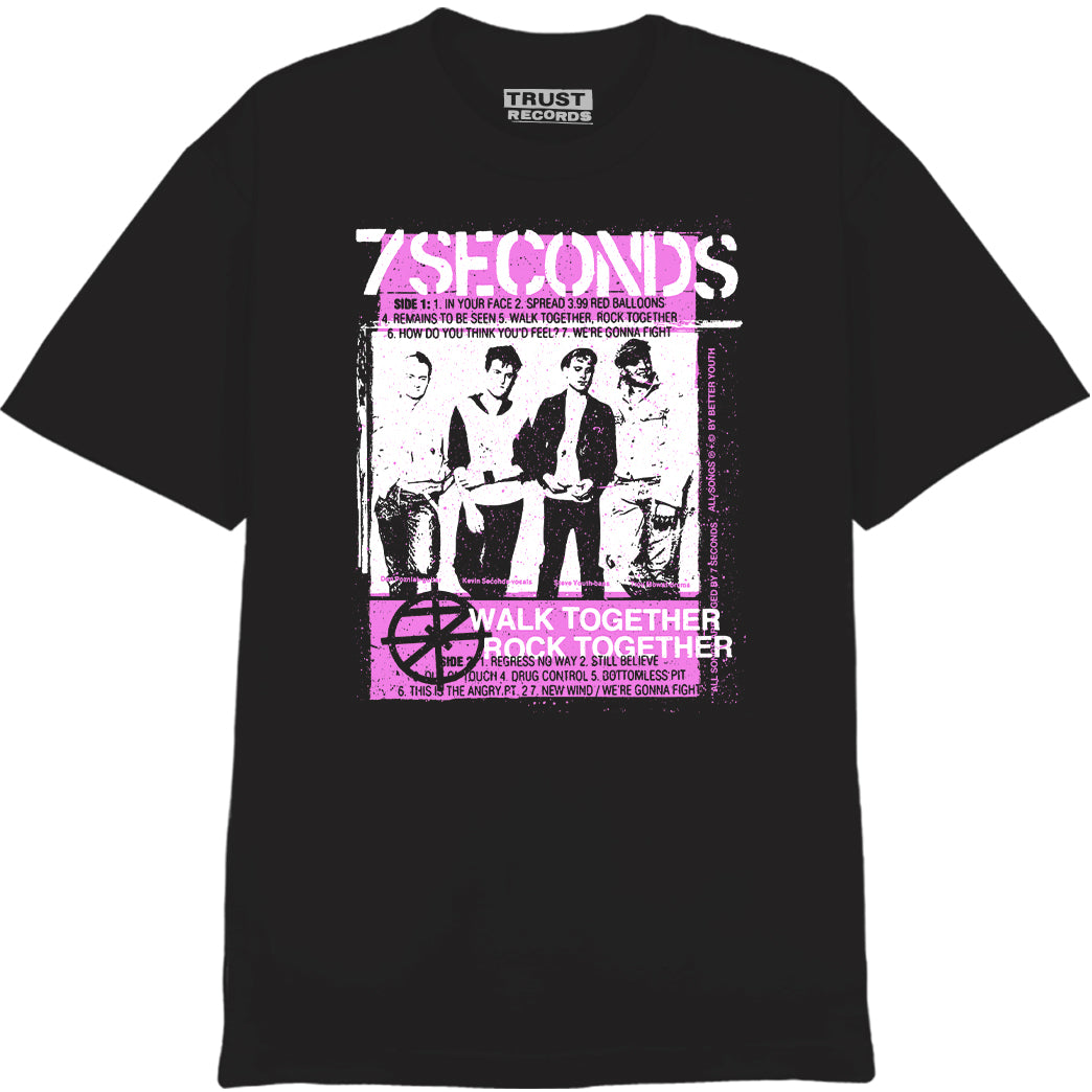 7 Seconds black T-shirt made from 100% cotton Alstyle 1301, featuring a black-and-white photo of the band with pink silkscreened 7 Seconds and Walk Together Rock Together text and graphic.