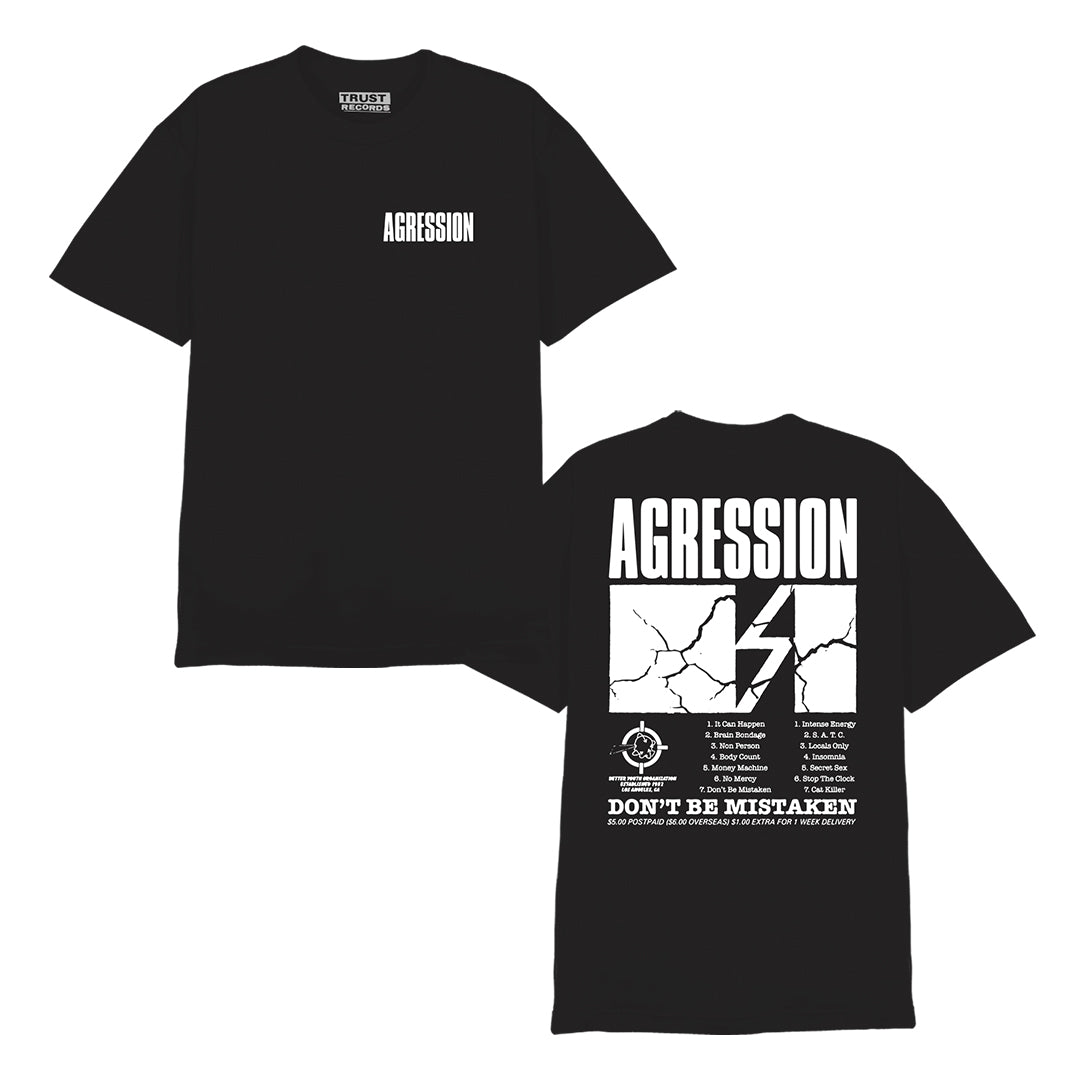 The black Agression Alstyle 1301 tee features a white AGRESSION print on the front left chest. The back sports large AGRESSION text with a cracked design, lightning bolt, extra wording, and “DONT BE MISTAKEN” at the bottom. 100% cotton.