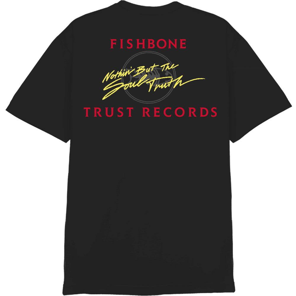 A black Fishbone Comfort Colors T-shirt featuring a small circular yellow and red ant logo on the left chest and a Trust Records label inside the collar.
