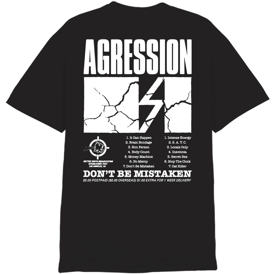Agression black T-shirt on 100% cotton Alstyle 1301. Features bold cracked-white AGRESSION lettering, lightning bolt, song list, and DONT BE MISTAKEN at the bottom with small logos and delivery info.