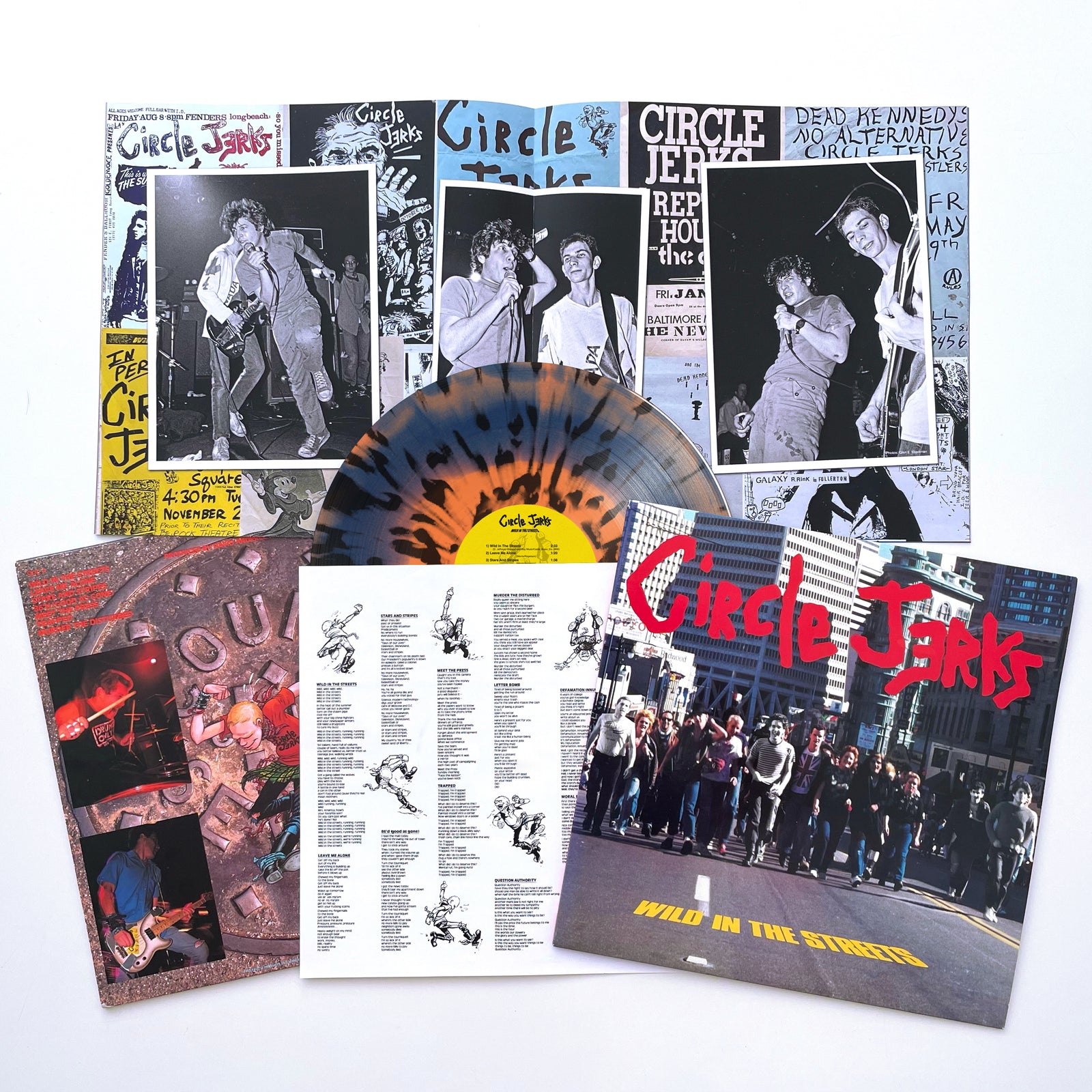 The Circle Jerks Wild in the Streets Deluxe Anniversary Edition LP, remastered from original analog tapes, with cover, band photos, lyric sheets, and extra album artwork are displayed on a white surface.