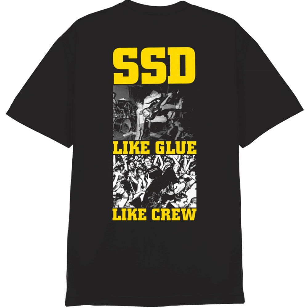 Black t-shirt by SS Decontrol featuring bold yellow SSD text at the top, two black-and-white band and crowd photos in the center, and "LIKE GLUE LIKE CREW" in yellow below. American Apparel fit.