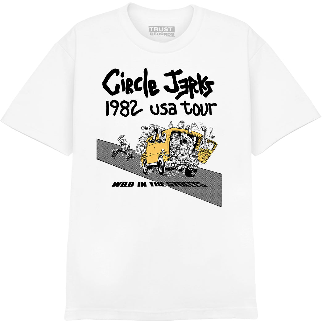 White T-shirt by Circle Jerks, silkscreened on Alstyle 1301, features a cartoon of people jumping from a yellow van with “1982 USA Tour” above and “Wild in the Streets” below, referencing the iconic punk band’s tour.