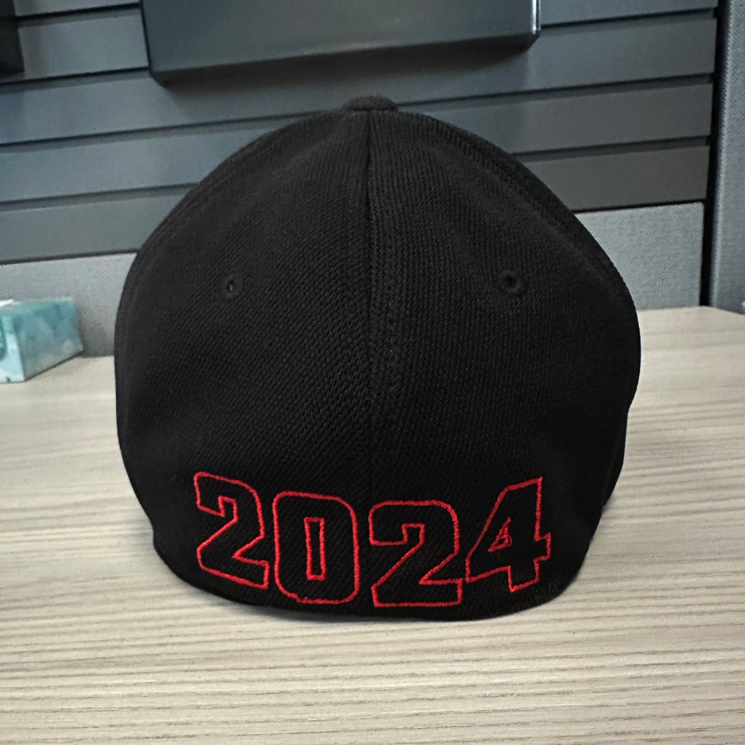 A black SS Decontrol Flexfit Baseball Hat with SSD embroidered in an American flag pattern, featuring two brim stickers—Cool&Dry and sizing details—a perfect pick for fans of the SSD Democracy Hat collection.