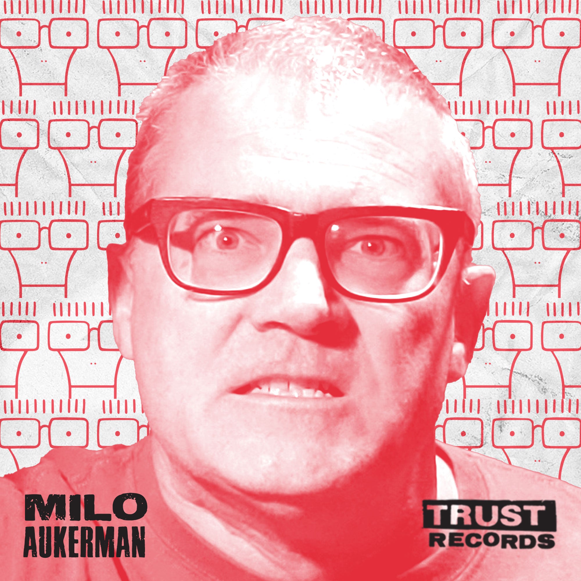 A man with glasses stares intensely forward against a patterned background of cassette tapes. The image has a red tint. Text reads Milo Aukerman in the bottom left and Trust Records in the bottom right.