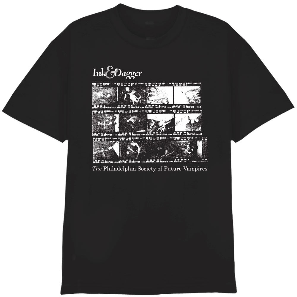 Ink & Dagger black Comfort Colors T-shirt with a white film strip-style graphic and "Ink & Dagger" plus "The Philadelphia Society of Future Vampires" text printed on the front.