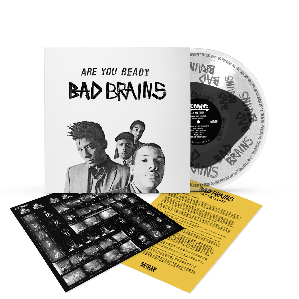 Vinyl record set for Bad Brains Are You Ready? featuring the album cover with a black-and-white band photo, a clear Bad Brains vinyl record pressed at Inner Ear Studios, a yellow lyric sheet, and a sheet of photo negatives—including exclusive material from the iconic “Pay to Cum” first recording.