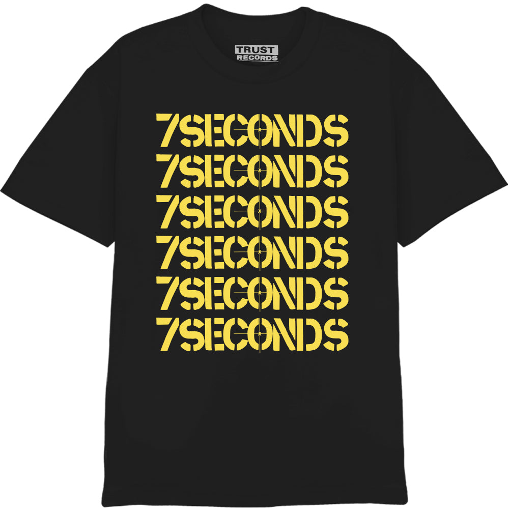 A black 100% cotton 7 Seconds T-shirt featuring 7SECONDS seven times in bold yellow stencil letters stacked down the front. TRUST RECORDS on the collar label. Silkscreened on American Apparel for lasting comfort.