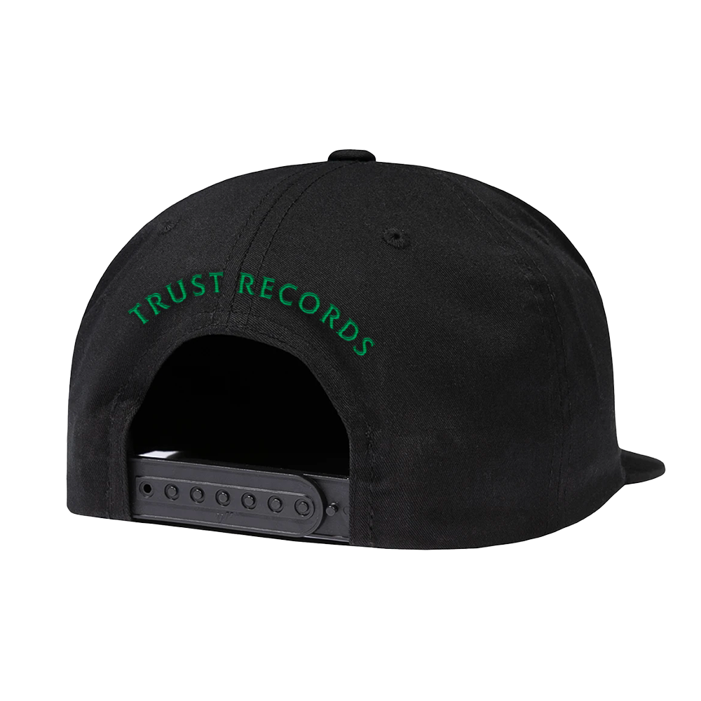 A black adjustable embroidered Fishbone cap viewed from the back, with green “TRUST RECORDS” text above the strap—a classic hat for any collection.