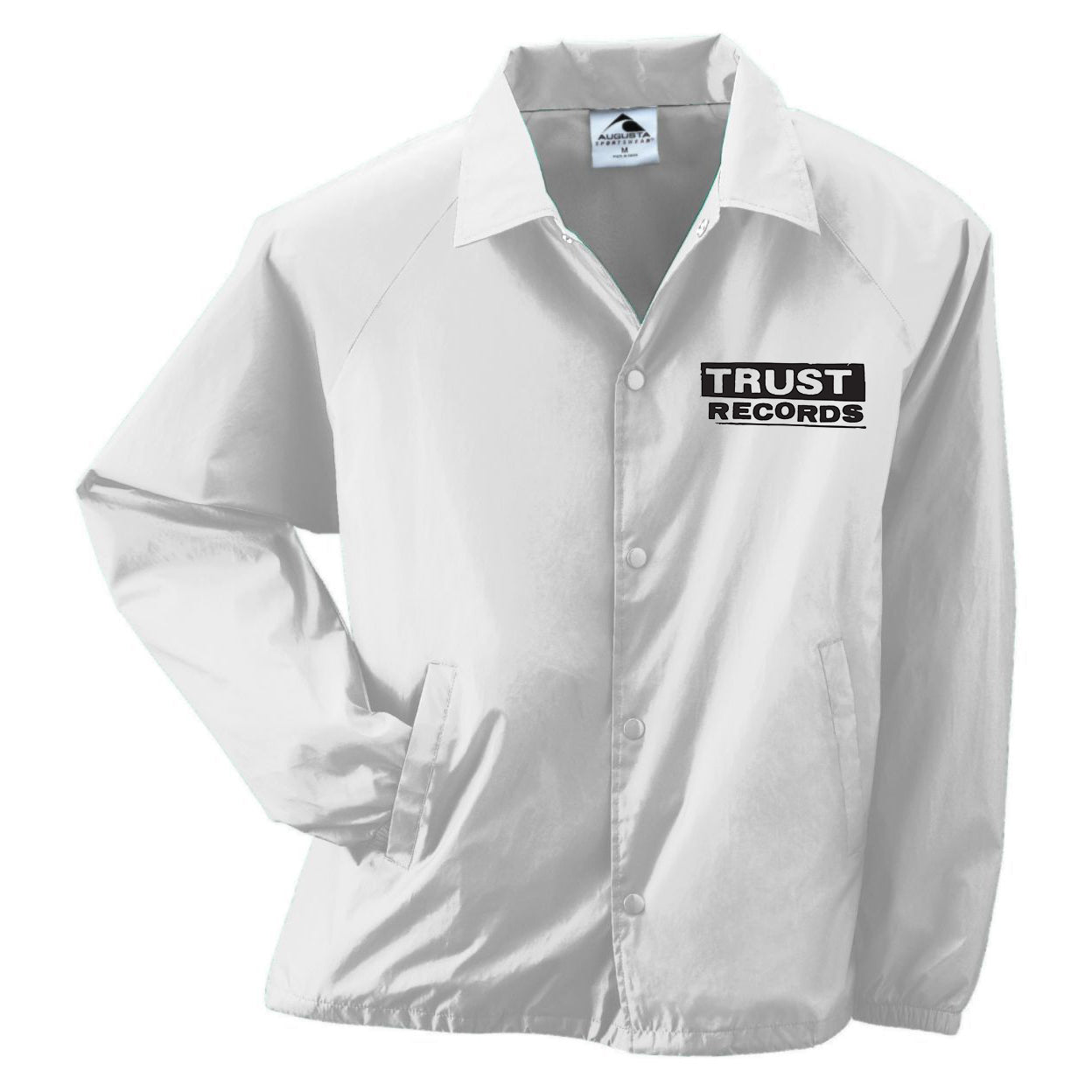 The Trust Records windbreaker is a white jacket with front pockets and "TRUST RECORDS" printed in black on the left chest, blending classic style with bold branding.