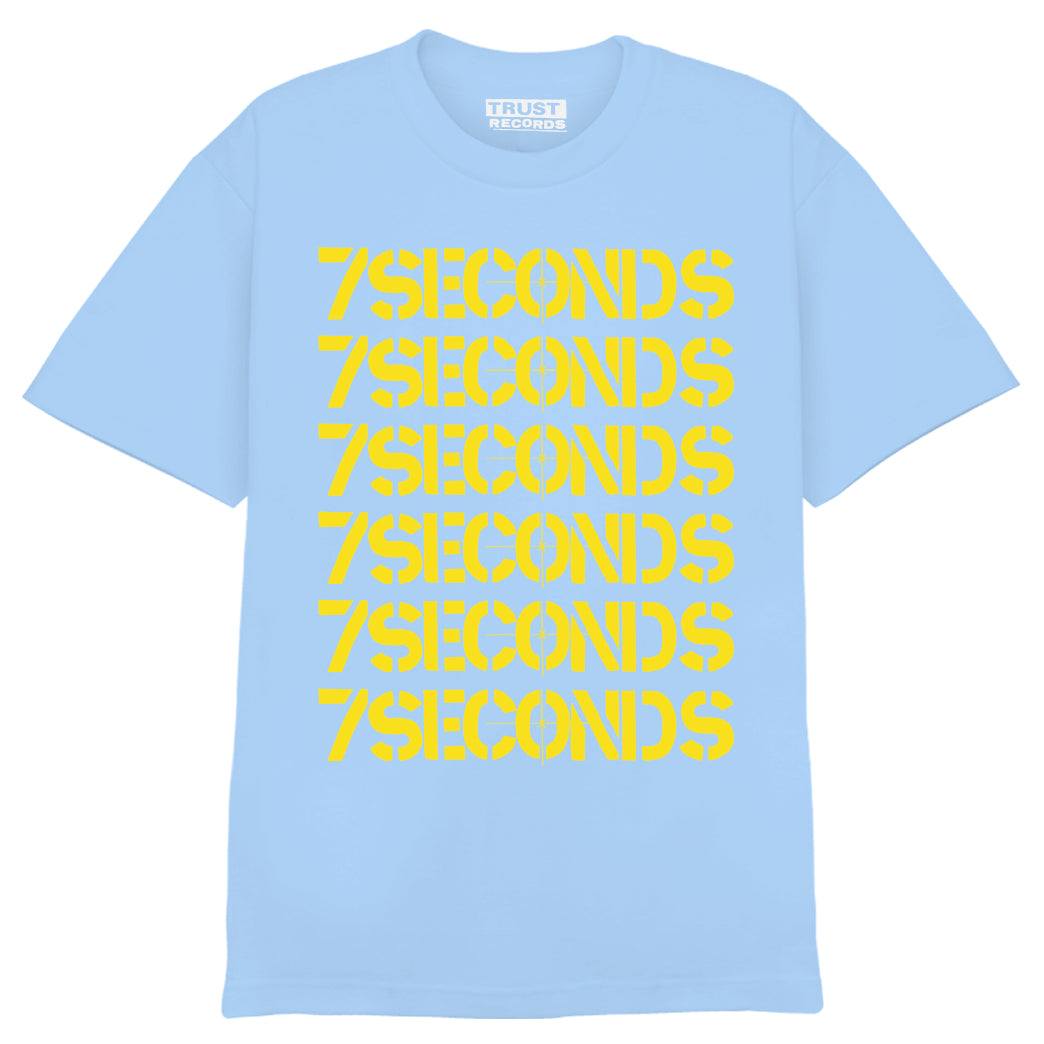 Light blue 100% cotton T-shirt by 7 Seconds with 7SECONDS in bold yellow, repeated six times in a stacked column on the front.