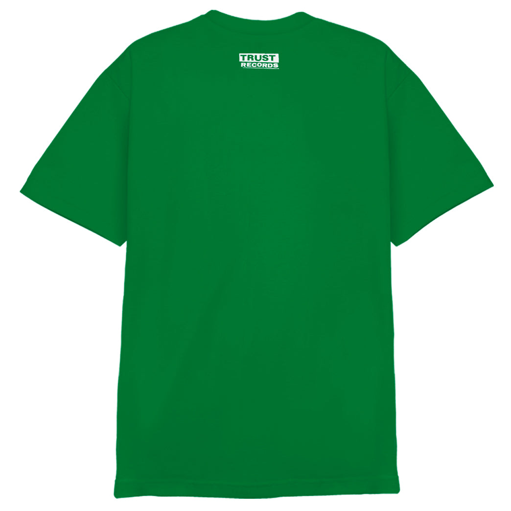 A plain green Alstyle 1301 T-shirt by Circle Jerks, shown from the back. A small white TRUST RECORDS logo is centered near the neck. Made from 100% cotton for comfort and durability.