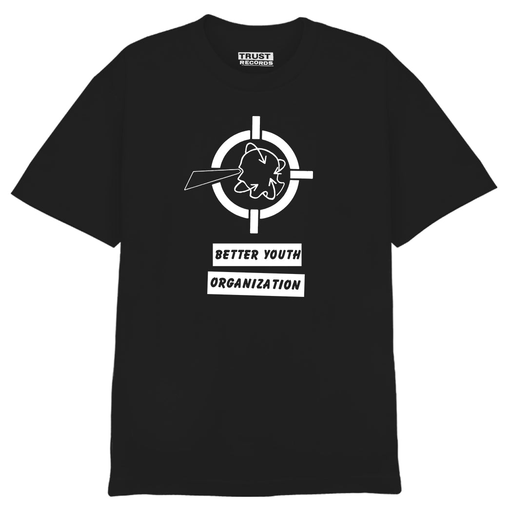 Better Youth Organization black tee, silkscreened on 100% cotton, features a white punk head graphic in a target above “BETTER YOUTH ORGANIZATION.” Alstyle 1301 label inside collar reads “TRUST RECORDS.”.