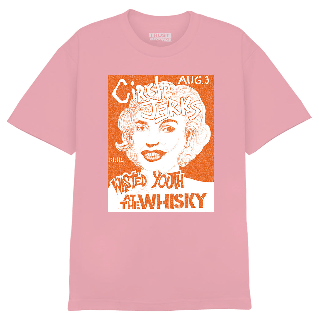 A pink Circle Jerks T-shirt with an orange and white graphic of a womans face, featuring Circle Jerks Aug. 3 + Wasted Youth at the Whisky A Go Go from a classic punk show. Brand: Circle Jerks.