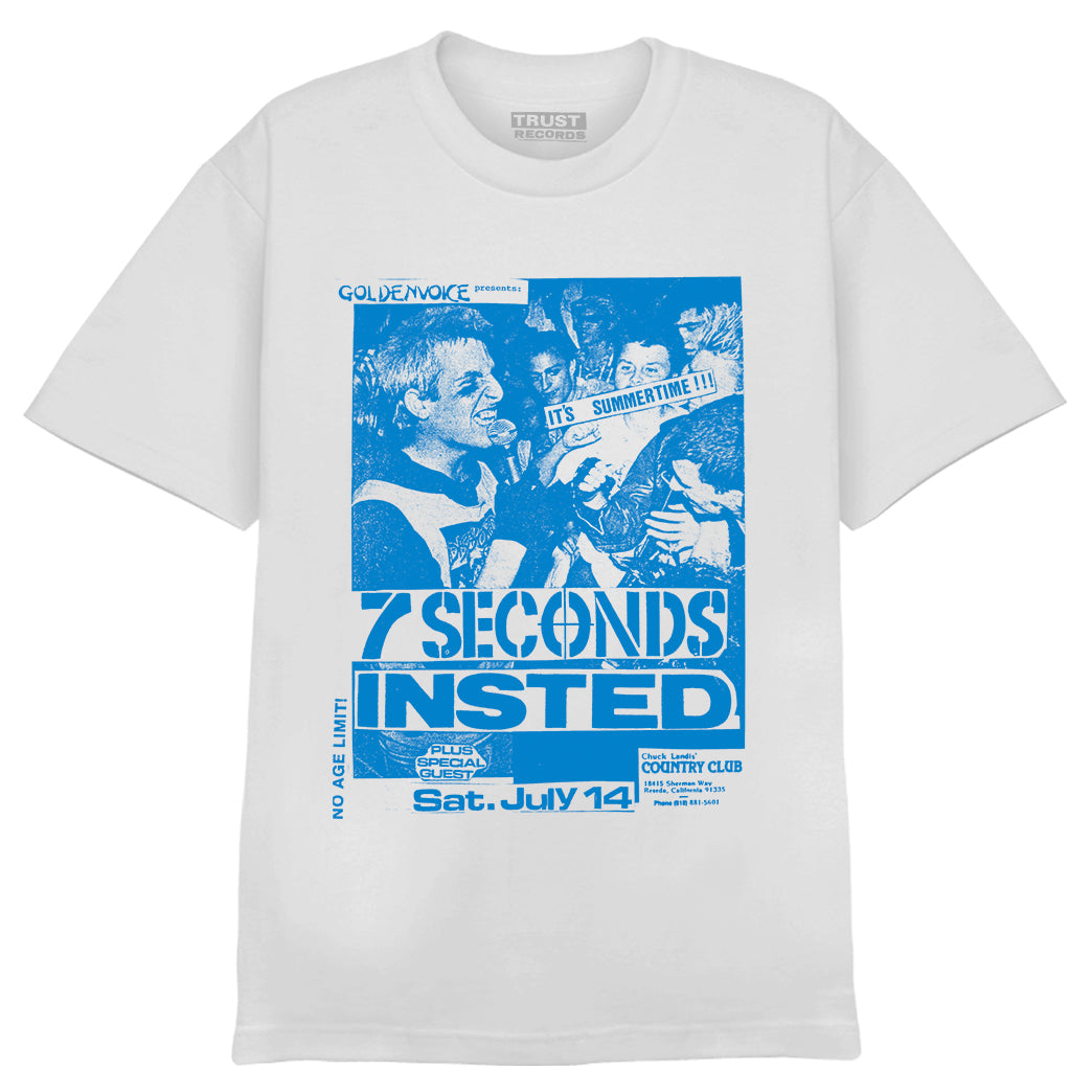 White T-shirt by 7 Seconds with a blue graphic of a punk concert flyer. Features a singer performing, crowd, and text: “7 Seconds, Insted, Sat. July 14, Country Club” plus various logos.