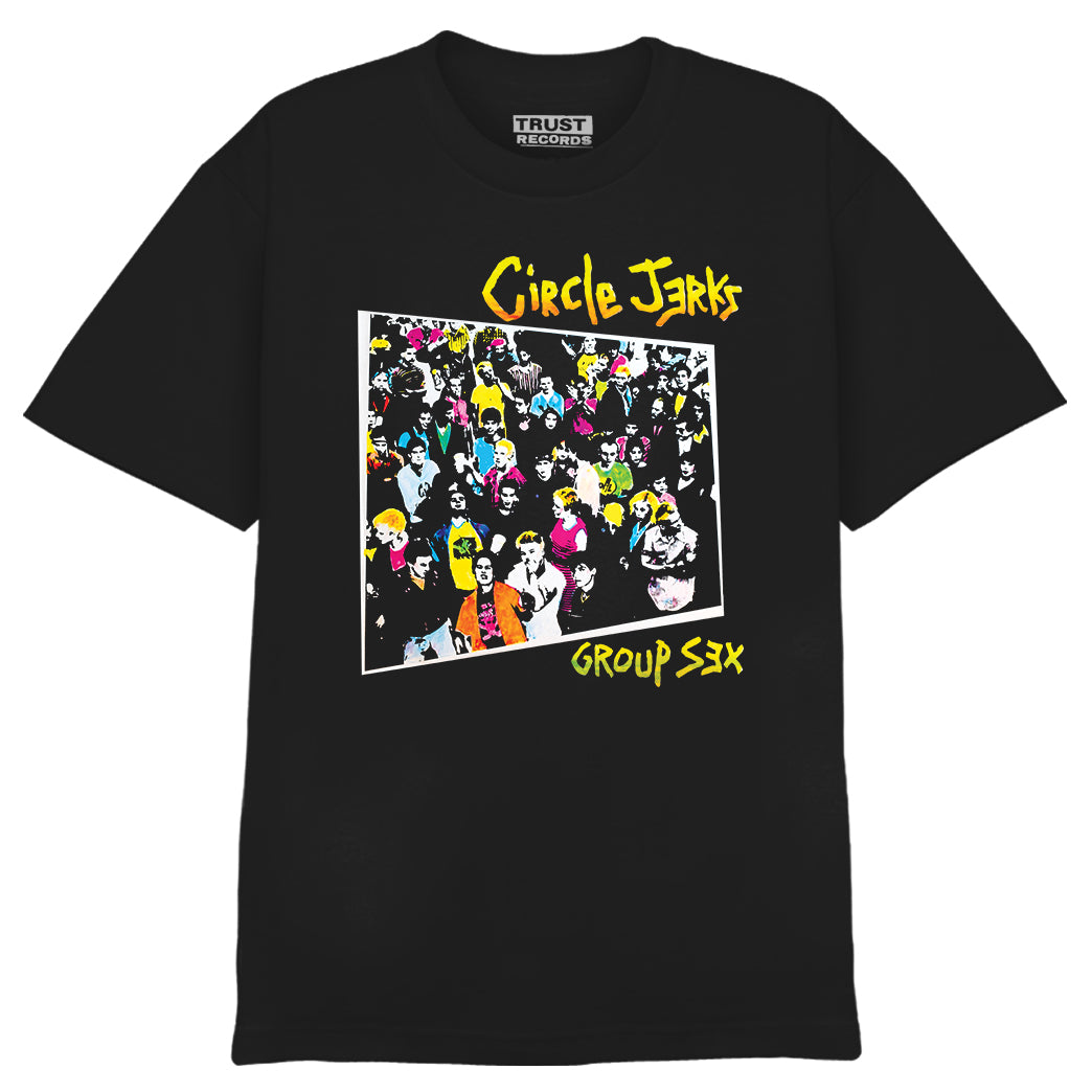 The Circle Jerks Alstyle 1301 black T-shirt is 100% cotton, with a colorful cartoon crowd scene and yellow "Circle Jerks" and "Group Sex" text silkscreened on the front; Trust Records tag.