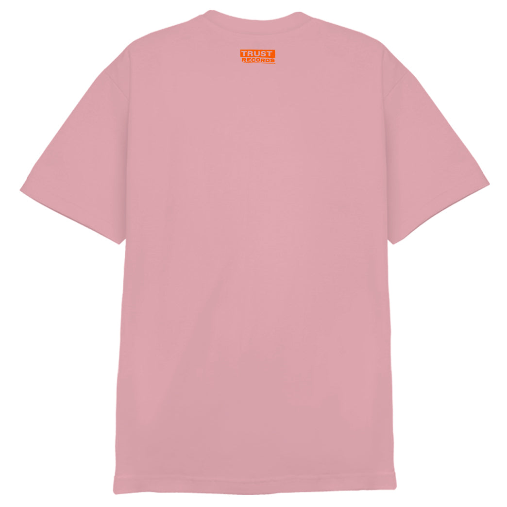 A pink Circle Jerks T-shirt with an orange and white graphic of a womans face, featuring Circle Jerks Aug. 3 + Wasted Youth at the Whisky A Go Go from a classic punk show. Brand: Circle Jerks.