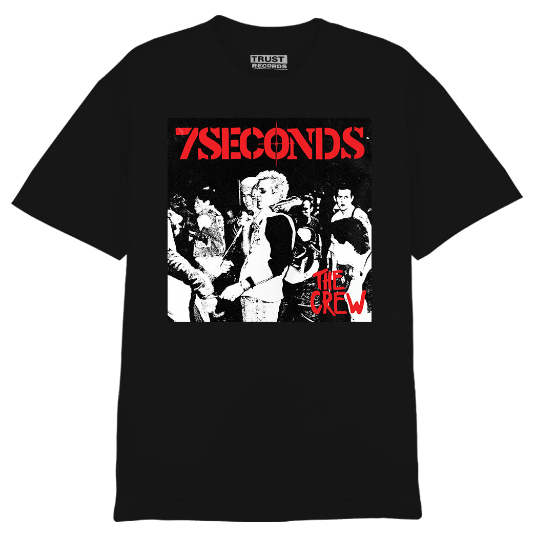 Black 7 Seconds T-shirt with The Crew album cover in red and white, silkscreened on high-quality Alstyle 1301, 100% cotton. Features punk group artwork with a blond-haired figure shaking hands.
